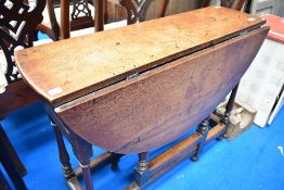 A period style oak gateleg table having narrow top and turned frame
