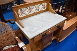 A Victorian wash stand having marble top and tile back