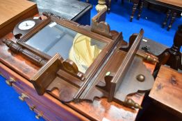 A reproduction hall mirror with clock and shelf features