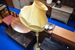 A traditional French style standard lamp with period shade