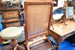 A traditional mahogany framed fire screen/table having tilt top