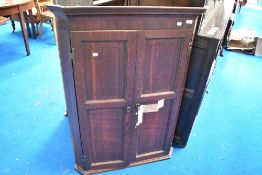 A George III oak wall corner cupboard