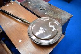 A traditional copper warming pan