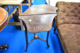 An Edwardian mahogany triangular occasional table having triple drop flaps and extensive inlaid