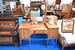 A 19th Century mahogany dressing table having large brass handles and inlaid decoration, width