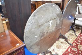 A 19th Century oak circular pedestal table having snap top