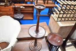 A Victorian style mahogany wine table with candle or smoking stand