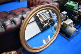 An oval gilt frame mirror