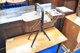 A vintage cantilever sewing box and contents , on stylised legs