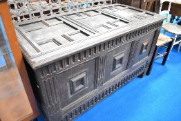 A 17th Century and later oak kist in the Jacobean style having typical cushioned panelling and later