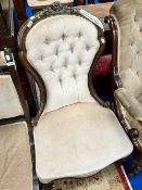A Victorian spoon back nursing chair having later button back dralon upholstery