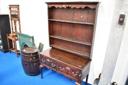 A period oak dresser having triple delft rack to back , two deep frieze drawers with brass handles