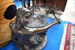 A modern bronze effect coffee table modelled as ballet dancer having oval glass top (being sold