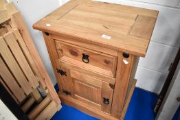 A modern pine bedside cabinet
