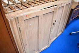 A stripped pine cupboard base