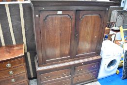 An 18th Century oak linen press having four drawers to base, width 145cm