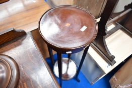 An early 20th Century mahogany jardinere stand with undertier