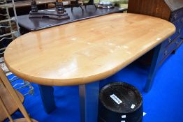 A modern beech top oval kitchen table having metal legs, approx. 150 x 72cm