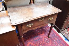 A Georgian oak side table having frieze drawer with brass handle and escutcheon on heavy cabriole