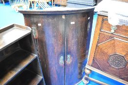 A 19th Century oak bow fronted corner cupboard