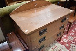 An Arts and Crafts style golden oak bedroom chest of three long drawers