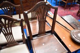 A pair of 19th Century dining chairs having splat backs and solid seats