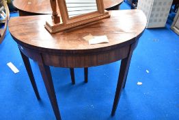 A 19th Century mahogany demi lune fold over card table