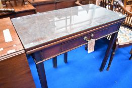 A 19th Century mahogany fold over tea table , having frieze drawer with brass drop handle
