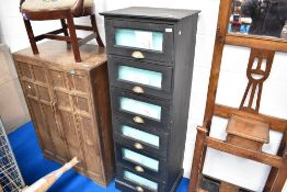 A painted pine chest of six merchants style drawers with glass fronts and brass handles