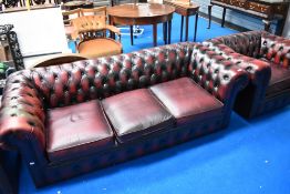 A modern/vintage red leather chesterfield settee and chair