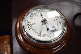 A vintage mahogany framed aneroid barometer