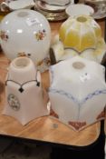 Four early 20th century Art Deco glass light shades with printed and painted patterns.