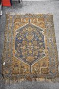 An antique Persian or Caucasian woven wool rug or prayer mat. 110cm x 82cm