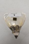 A vintage container made from mother of pearl shell with an Indian silver top.