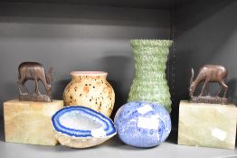 A pair of vintage Onyx book ends with wooden gazelle tops, a blue geode and studio pottery items.