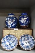 Two ginger jars, having cherry blossom decoration on blue ground, and two Japanese bowls.