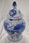 A large floor standing Chinese urn having printed blue and white ware design with lid in very fine