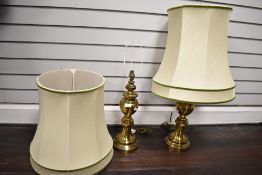 A vintage pair of brass baluster lamp bases with appropriate matching shades. Lamp bases measure