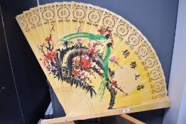 A large sized vintage Chinese fan with hand decorated wooden blades depicting birds of paradise.