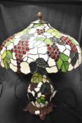 A vintage large Tiffany style laded light lamp having twin light to shade and light up central