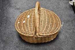 A vintage picnic hamper in wicker cane. 54cm long.