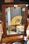 A Victorian mahogany bathroom mirror.