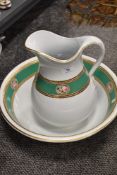 An early 20th century wash jug and bowl set with floral green and gilt design.