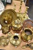 A selection of brass ware, including Indian Lassi cups, charger with traditional Indian scenes,