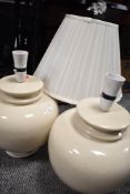 Two large modern ceramic lamp bases in a cream glaze.