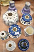 A collection of Jersey pottery including candlesticks, posy vases and a jug.