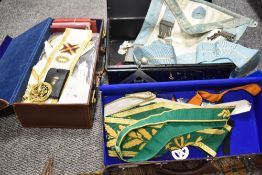Three cases of Masonic regalia including medals, pendants, tabards and ephemera.
