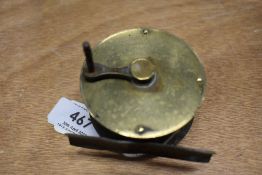 A vintage brass, crank wind eaton and deller fly reel missing its ivory or bone handle