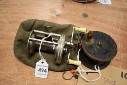 A Pflueger Buckeye cross-wind spinning reel and a small vintage fly reel