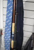 A Daiwa carbon 2pc whisker rod and an unmarked 2pc surf rod both in soft cases